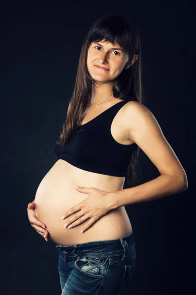 Pregnant woman holding her belly — Stock Photo, Image