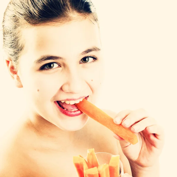 Teen girl biting carrot — Stock Photo, Image