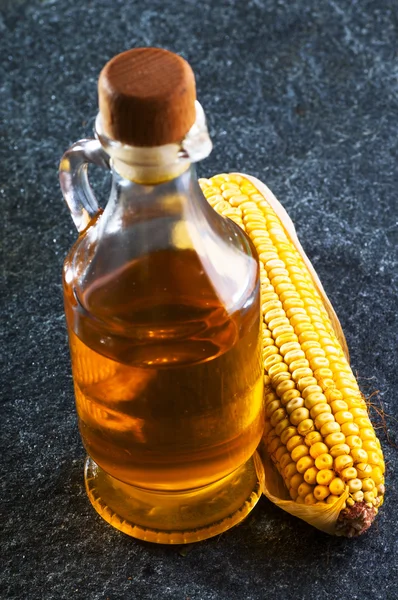 Dried corn and oil bottle — Stock Photo, Image