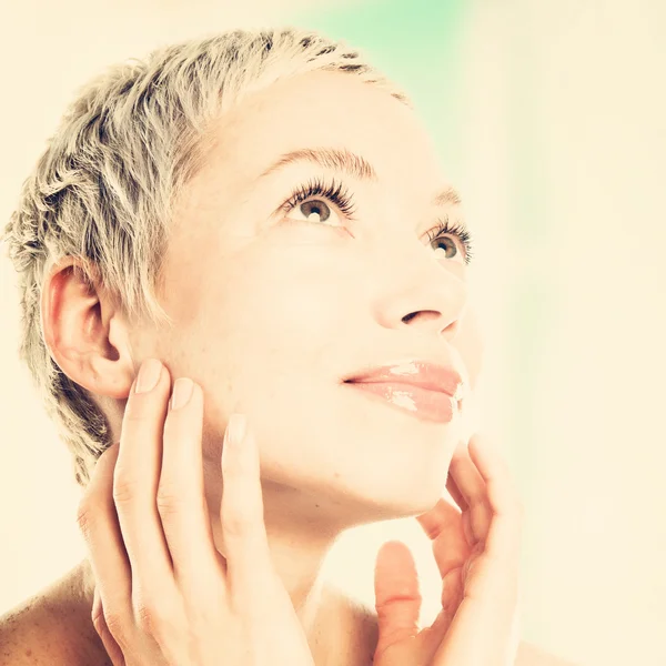 Woman touching her face — Stock Photo, Image