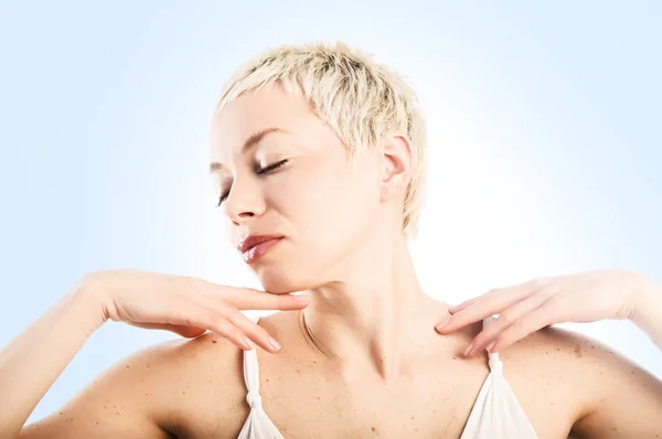 Woman touching her face and shoulder — Stock Photo, Image