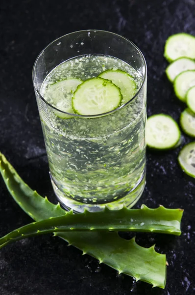 Glass of water with cucumber slices and aloe — Stock Photo, Image