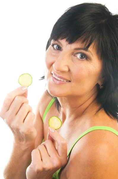 Mature holding slices of cucumber — Stock Photo, Image