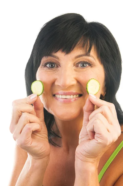 Mature holding slices of cucumber — Stock Photo, Image