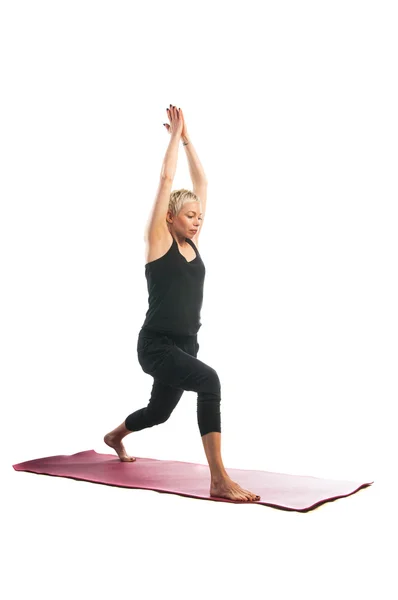 Vrouw in Virabhadrasana yoga pose — Stockfoto