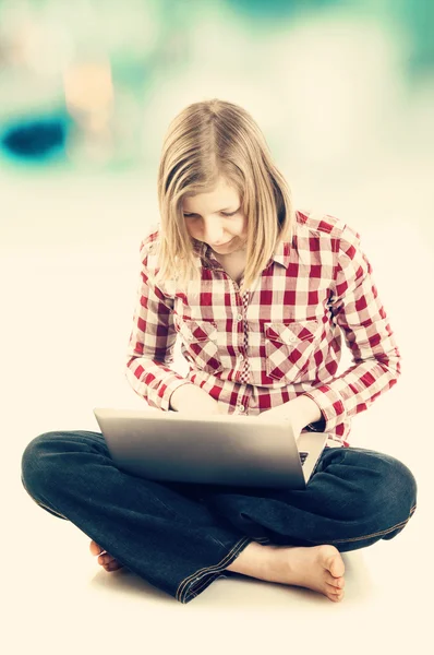 Дівчина-підліток використовує ноутбук — стокове фото