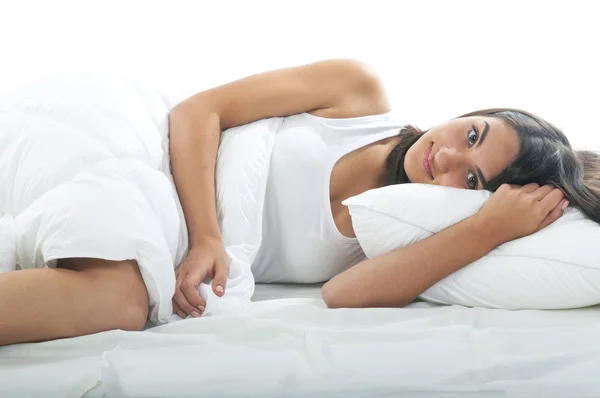 Young woman lying in bed — Stock Photo, Image