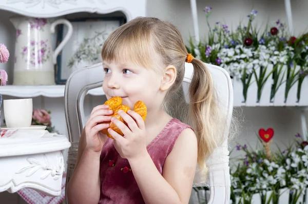 Menina comendo croissant — Fotografia de Stock