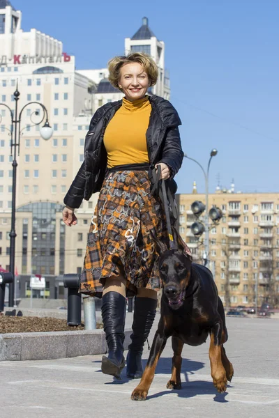 Pretty adult woman with dog outdoors — Stock Photo, Image
