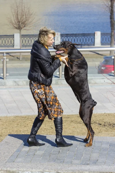 Pretty adult woman with dog outdoors — Stock Photo, Image