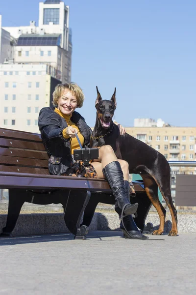 Pretty adult woman with dog outdoors — Stock Photo, Image