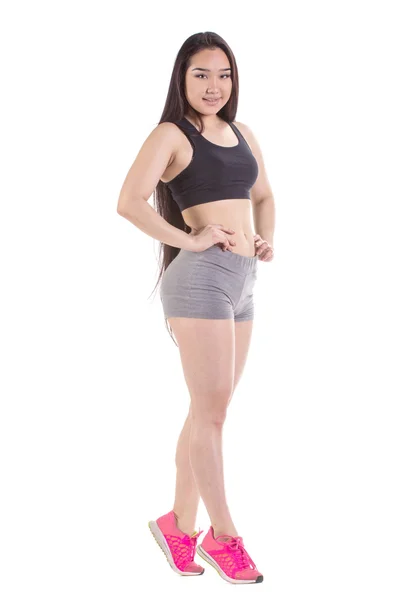Mujer de fitness hermosa de pie - aislado sobre un fondo blanco —  Fotos de Stock