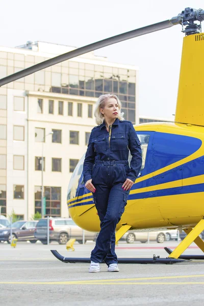 Pretty pilot woman on helicopter background — Stock Photo, Image