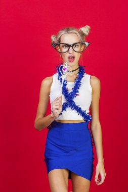 Komik gözlük mavi etek bl ile sevimli gülümseyen genç kadın