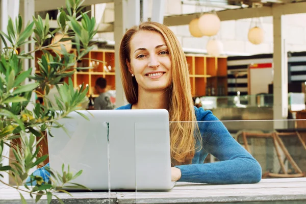 Frau mit Laptop in Café im Freien. — Stockfoto