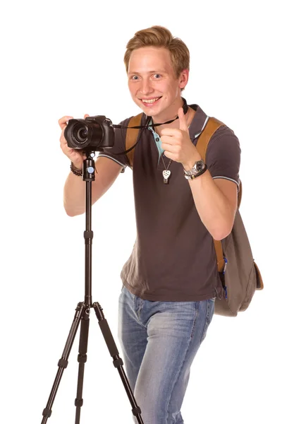 Joven con cámara en trípode — Foto de Stock