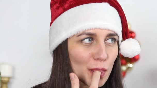 Girl in Santa hat eats cupcake — Stock Video