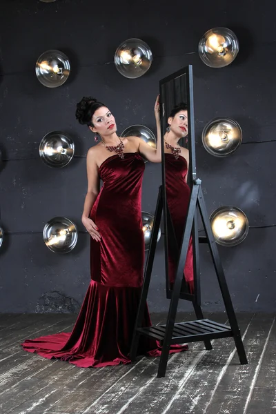 Lady in red and magic mirror — Stock Photo, Image