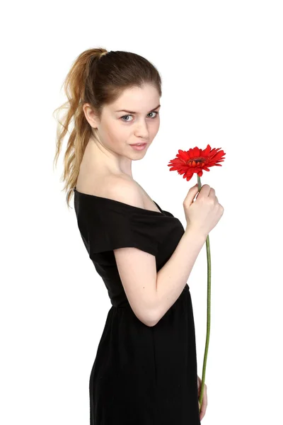 Menina bonita com flor em vestido preto — Fotografia de Stock