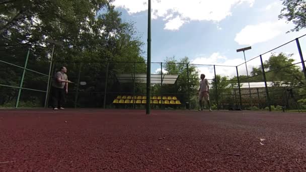 Dva muži, hrát badminton na kurtu — Stock video