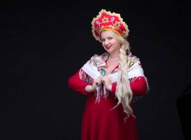 Girl standing in Russian traditional costume. Woman is wearing s clipart