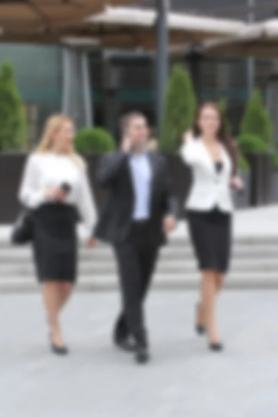 Businessman walking on the street with their secretaries, in front of office.