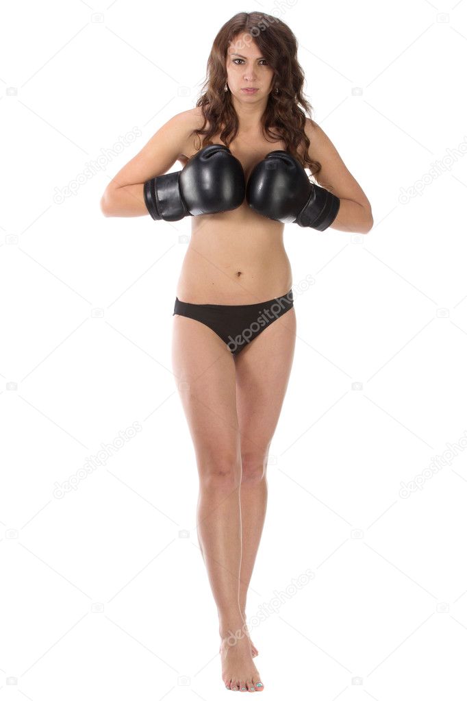 Sexy young brunette woman with black boxing gloves covering brea