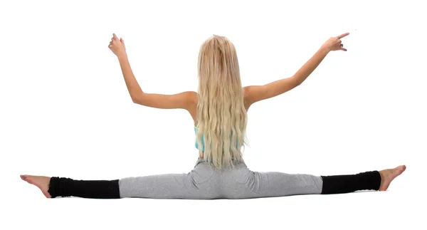 Handsome girl posing while doing gymnastic split — Stock Photo, Image