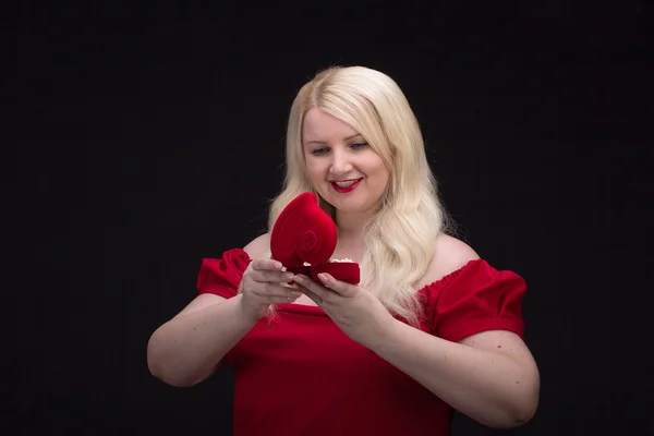 Plus size woman in red dress with gift box — Stock Photo, Image