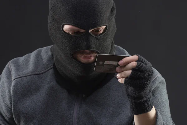 Hacker hold stolen credit card — Stock Photo, Image