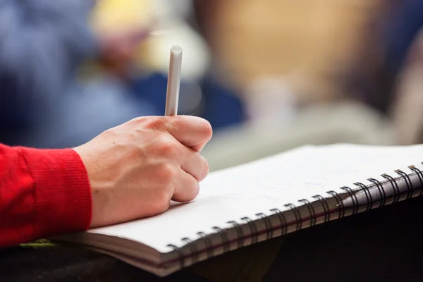 Tomando notas na conferência, detalhe . Imagem De Stock