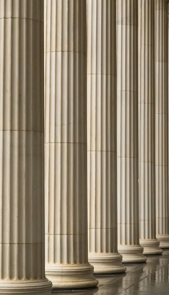 Many old greek columns with reflection — Stock Photo, Image