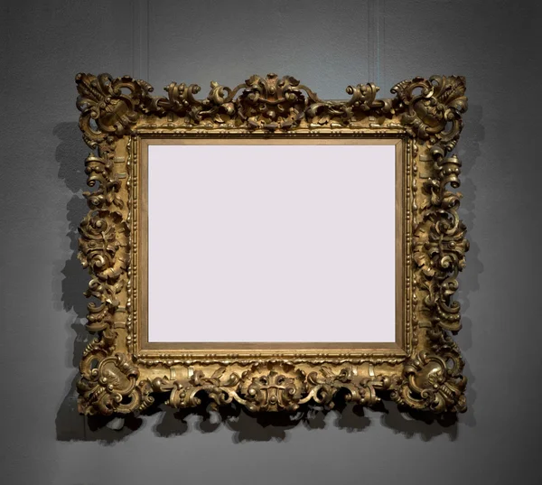 Golden decorative frame for painting on wall — Stock Photo, Image
