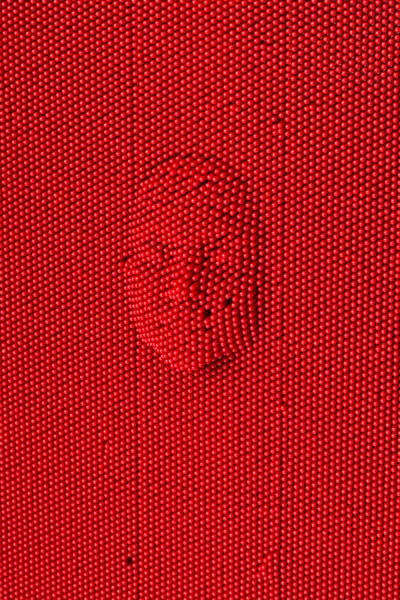 Face pressed to red pin art board — Stock Photo, Image