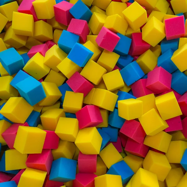 Colored foam rubber cubes background — Stock Photo, Image