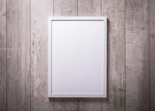 Blank white picture frame on the wood wall — Stock Photo, Image