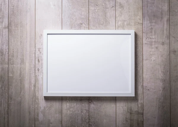 Blank white picture frame on the wood wall — Stock Photo, Image