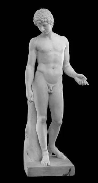 Старинная скульптура обнаженного молодого человека из белого мрамора. Античная классическая статуя молодого человека, изолированная на черном. Каменная фигура подростка — стоковое фото