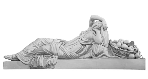 Old statue of sensual renaissance era woman laying with basket of fruits isolated on white background — Stock Photo, Image