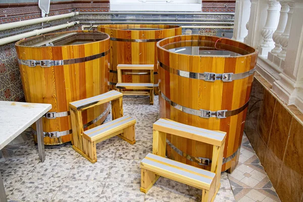 Western style wooden bathtubs in barrel shape. Spa treatments barrels cedar bath in wooden decoration. Wood buckets — Stock Photo, Image