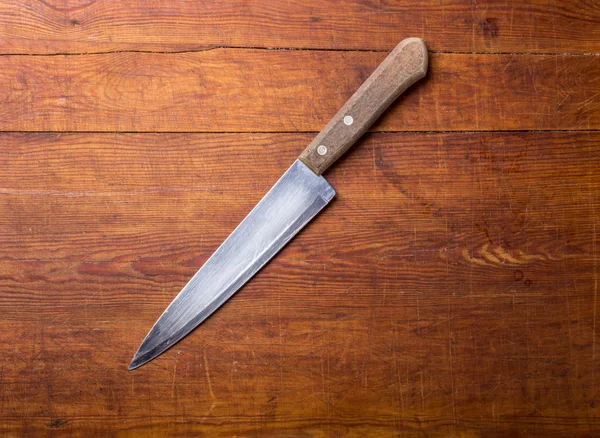 Knife on rustic kitchen table with copy space — Stock Photo, Image