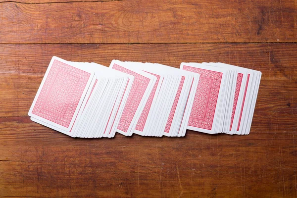 Dek van kaarten op houten tafel — Stockfoto