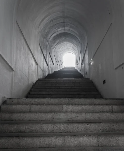 Light at the end of tunnel with ascending stairs — Stock Photo, Image