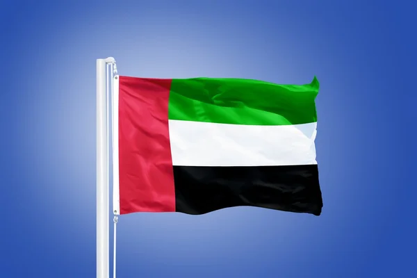 Vlajka Spojených arabských emirátů létal proti modré obloze — Stock fotografie
