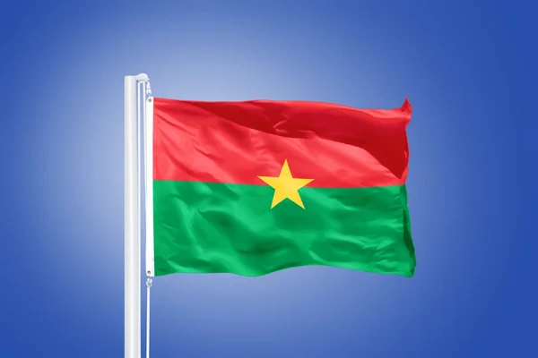 Flaga z Burkina Faso pływające przeciw błękitne niebo — Zdjęcie stockowe