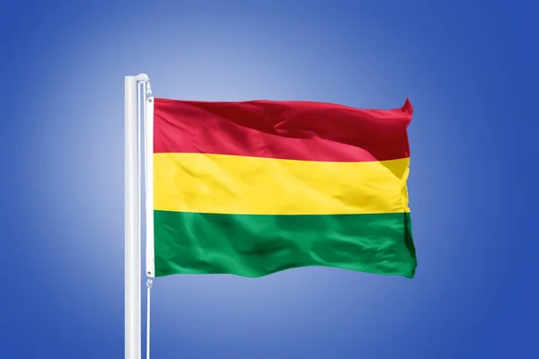 Flag of Bolivia flying against a blue sky — Stock Photo, Image