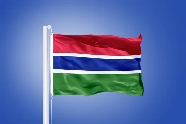 Vlajka Gambie létal proti modré obloze — Stock fotografie