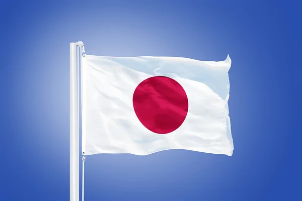 Flag of Japan flying against a blue sky — Stock Photo, Image