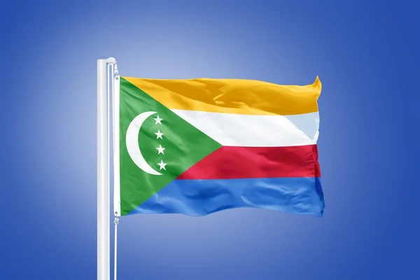 Flag of Comoros flying against a blue sky — Stock Photo, Image