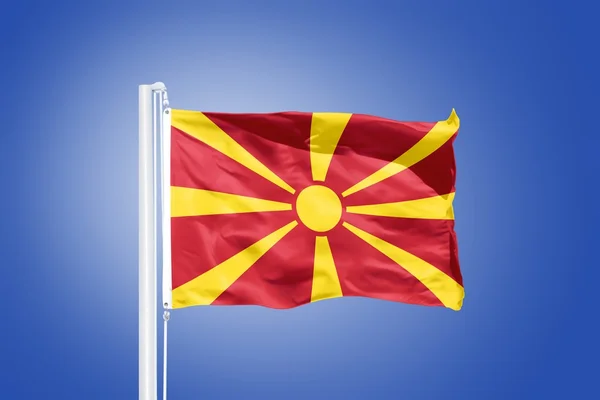 Flag of Macedonia flying against a blue sky — Stock Photo, Image